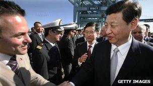 Chinese Vice President Xi Jinping, right, shakes hands with Los Angeles City Councilman Joe Buscaino as he tours China Shipping on 16 February, 2012 at the Port of Los Angeles in San Pedro, California