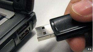 USB memory stick being inserted into laptop (generic)