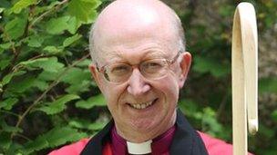 Bishop of Oxford to walk on hot coals for charity - BBC News