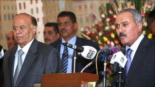 Ali Abdullah Saleh and Abdrabbuh Mansour Hadi at the handover ceremony