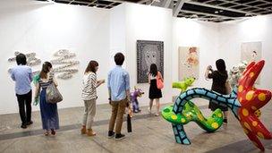 Visitors at ART HK look at an exhibit in May last year