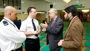 Police officers meeting with mosque members