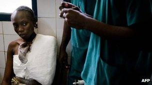 A Congolese woman is treated on March 5, 2012 in the central hospital for the injuries she suffered during the March 4 gigantic blast after an ammunition depot exploded in the capital of the Republic of Congo, Brazzaville, killing around 200 people and injured over 1000