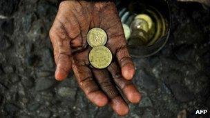 Beggar with coins, Manila