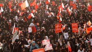 Women attend the anti-government march just outside Manama