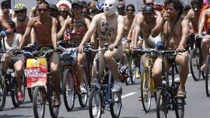 Hundreds of nude and semi-nude cyclists demanding that authorities stop the hostilities bicyclists face from motorists, pedal through a main avenue in Lima, Peru, Saturday March 10, 2012
