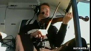 Playing a violin in a helicopter