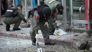 Thai bomb squad officials inspect the site of an explosion in Bangkok on February 14