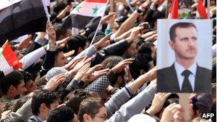 Syrians rally in support of the regime on the first anniversary of the anti-regime revolt