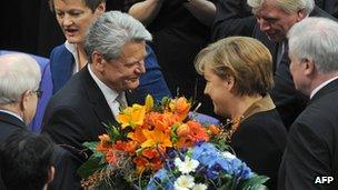 Joachim Gauck is congratulated by Angela Merkel at the Bundestag. Photo: 18 March 2012