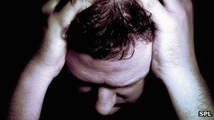 Man holding head