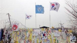 Messages of hope for reunification on a military barbed wire fence at Imjingak peace park in Paju near the Demilitarized Zone (DMZ) separating the two Koreas, 14 March, 2012