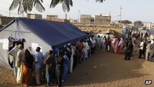 Voters wait to cast their votes in in the Guediawaye neighborhood of Dakar, Senegal, on 25 March 2012