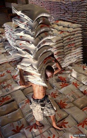 Man carrying rice in warehouse