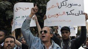 Egyptian protesters chant carry banners saying: "A constitution for all Egyptians must be written by the rebels, civilian constitution is our basic right." (28 March 2012)
