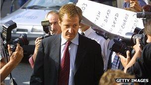 Alastair Campbell walks past a group of protesters and photographers as he arrives at the Royal Courts of Justice in London to testify at the Hutton Inquiry, 19 August, 2003.