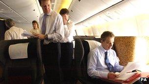 Alastair Campbell (left) with Tony Blair (right) in an aeroplane