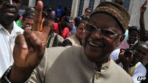 Carlos Gomes Junior flashes the victory sign after casting his vote at a polling station in Bissau on 18 March