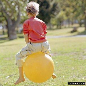 A child on a Space Hopper toy