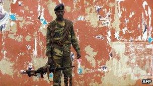 A soldier stands guard in a street near the National Assembly in Bissau, the capital of Guinea-Bissau, on 13 April 2012