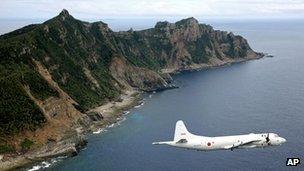 A Japan Maritime Self-Defence Force's P-3C Orion surveillance plane flies over the disputed Senkaku / Diaoyu islands in the East China Sea, 13 October 2011