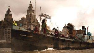 Giants on boat in the River Mersey