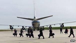 Secret Service walk behind Air Force One 25 April 2012