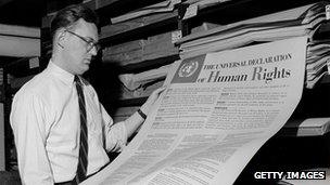 A man looks at one of the first documents published by the United Nations, The Universal Declaration of Human Rights, in 1955