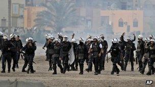 Riot police fire tear gas chase anti-government protesters during clashes in Sanabis, Bahrain (24 April 2012)