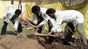 Police later exhumed the bodies of the killed men