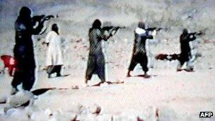 A video grab dated 19 June 2001 shows al-Qaeda recruits firing weapons at an Afghan training camp