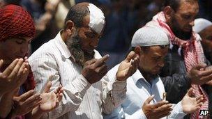Supporters of Salafist preacher Hazem Abu Ismail pray outside the Egyptian defence ministry building in Cairo (29 April 2012)