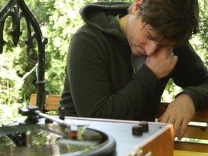 Musician and song-writer Adam Arcuragi listens to a newly minted vinyl recording