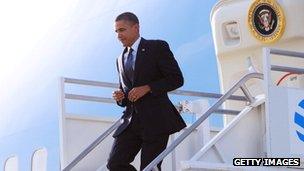 Barack Obama steps down off of Air Force One