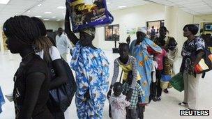 South Sudanese waiting to be flown back to their country arrive at Khartoum Airport May 14, 2012.