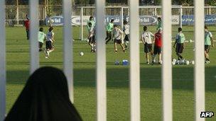 A woman looks at Iran's national football team practice in Tehran (2006)