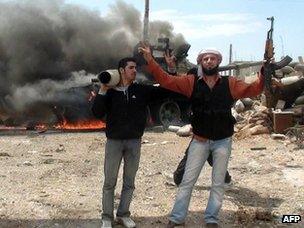 Free Syrian Army fighters celebrate destroying government weaponry near Rastan (14 May 2012)