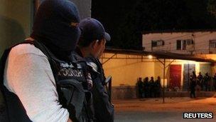 Policemen guard the outside of the prison in San Pedro Sula