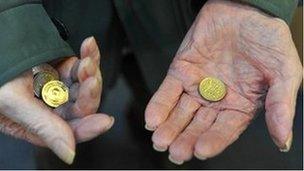 Old person holding coins