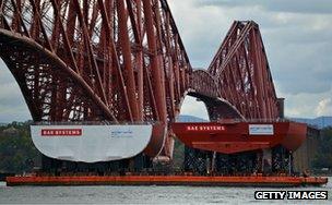 Hull section of aircraft carrier HMS Queen Elizabeth passes under the Forth Bridge