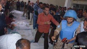 UN observers inspecting victims of the Houla massacre