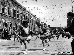 Children in London's East End enjoying a street party in celebration of the Coronation of Queen Elizabeth II, June 2nd 1953