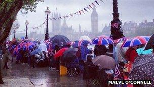 Royalists gahter in the rain by the Thames ahead of Jubilee Pageant
