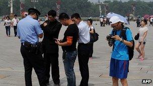 Police check people's papers in Tiananmen Square. 4 June 2012