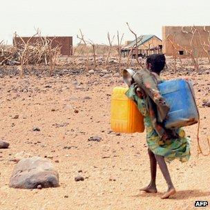 Girl carrying water canisters in Mauritania