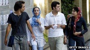 Young Iranian adults walking down a street