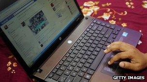 A Bangladeshi woman logs onto social networking website Facebook on her laptop in Dhaka