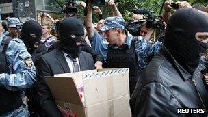 Russian security officials leave the home of opposition activist Alexei Navalny. 11 June 2012