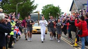 The Olympic Flame on the Torch Relay leg between Grantown-on-Spey and Tomintoul - Day 24