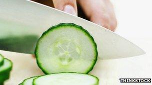 Person chopping cucumbers